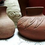 Α group of three vases sitting on top of a table